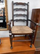 A child's ladder back elbow chair
