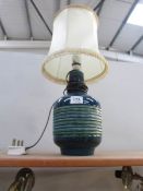 A ceramic table lamp with shade