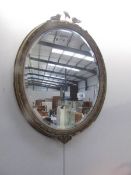 An oval gilt framed bevel edged mirror,