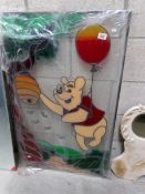 A stained glass depiction of Winnie the Pooh