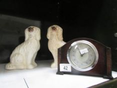 A pair of Staffordshire dogs and a clock