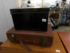 A metal deed box and a leather suitcase