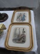 A pair of gilt framed and glazed fashion prints