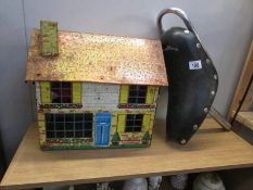 A tin plate dolls house and a Stingray bicycle seat