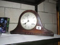 A mantel clock with key and pendulum