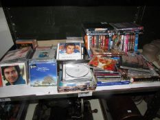 A large quantity of CD's and DVD's (one shelf)