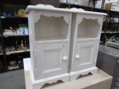 A pair of painted bedsides