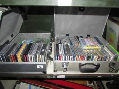 A large quantity of CD's in 2 metal cases (possibly camera cases)