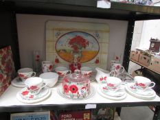 A quantity of poppy decorated tea ware etc