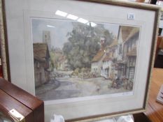 A framed and glazed village scene