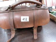 A pair of lawn bowls in leather case