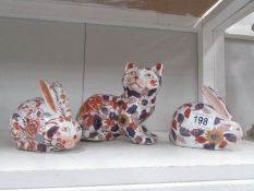 2 pottery rabbits and a cat