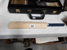 A signed miniature cricket bat,