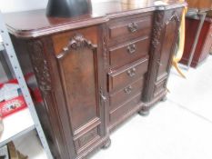 A 2 door mahogany sideboard with centre bank of 5 drawers