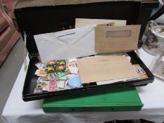 2 boxes and an album of stamps