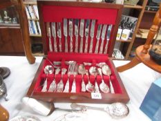 A cased canteen of cutlery with additional cutlery