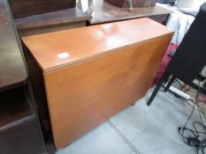 A teak drop leaf table