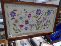 An embroidered fire screen