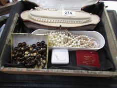 A box of costume jewellery including necklaces