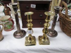 A pair of adjustable silver plate candlesticks and a pair of brass candlesticks