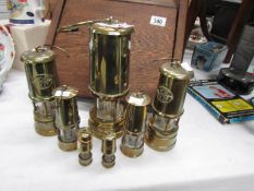 7 brass miner's lamps