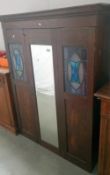 An art nouveau wardrobe with leaded glass decoration (missing base)