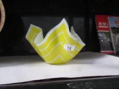 A yellow glass handkerchief bowl