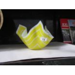 A yellow glass handkerchief bowl