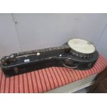A cased banjo with mother of pearl inlay