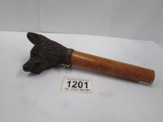 A walking cane handle with carved dog head