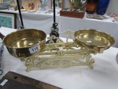 A set of old continental scales with brass pans and weights