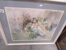 A framed and glazed impressionist style print of a young woman in a garden