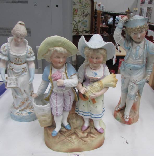 A 19th century continental bisque figure group and 2 other bisque figures