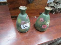 A pair of hand painted vases
