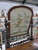 A mahogany toilet mirror inset with tapestry