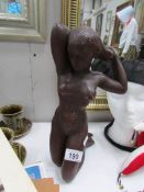 A kneeling figure of a nude female