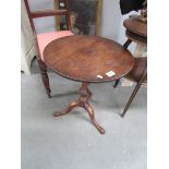 A mahogany tripod table