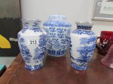 A pair of blue and white vases and a ginger jar