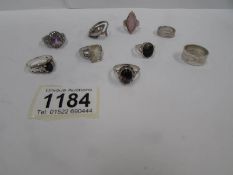 9 silver rings, some set Topaz,