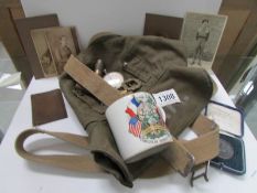 A small collection of militaria including medal, cap badges,