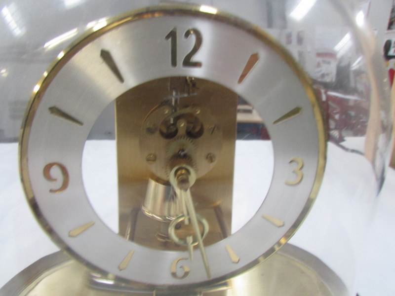 A brass clock under acrylic dome - Image 2 of 2