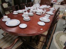 A mahogany extending dining table and 8 chairs