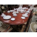 A mahogany extending dining table and 8 chairs