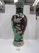 An oriental hand painted vase decorated with exotic birds and flowers