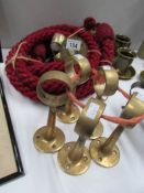 A quantity of brass brackets and a red rope