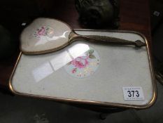 A dressing table tray and hand mirror
