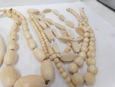 A quantity of ivory jewellery including bead necklaces and a cross