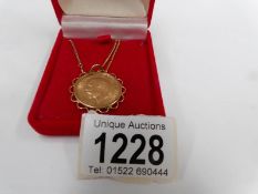 A 1911 gold sovereign pendant on 9ct gold chain and with safety chain (11gms)