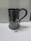 A late 18th / early 19th century plated tankard with wooden base