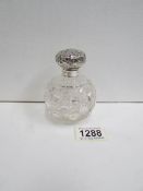 A hobnail cut scent bottle with silver top,